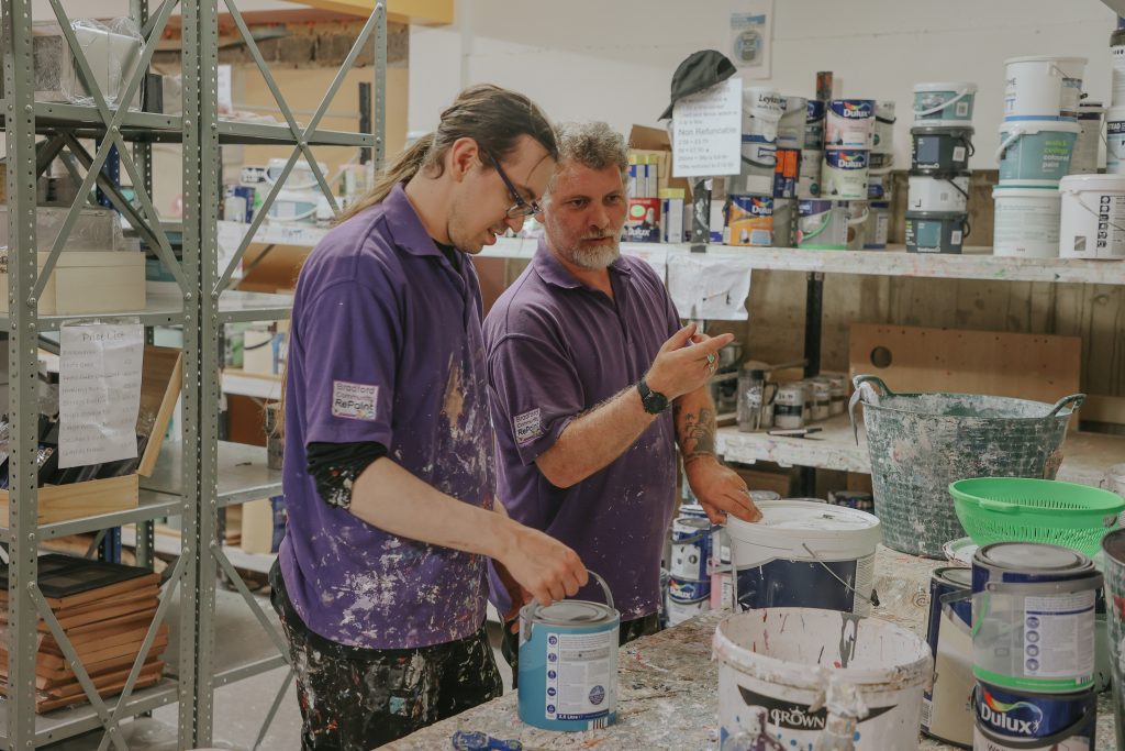 2022_YH_Bradford Organic Communities Service (Bradford Community RePaint)_2 people with paint pots in shop_ASS & CLI_LTW_01